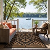 GENIMO Outdoor Rug for Patio Clearance, 5’x8′ Reversible Plastic Straw Rugs, Lightweight Waterproof RV Camping Mat for Camper, Balcony, Deck, Backyard, Picnic, BlackBrown(Black & Orange Aztec)
